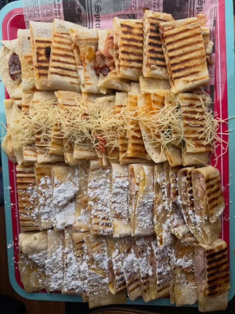 Dessert quesadilla pieces with caramel drizzle and powdered sugar